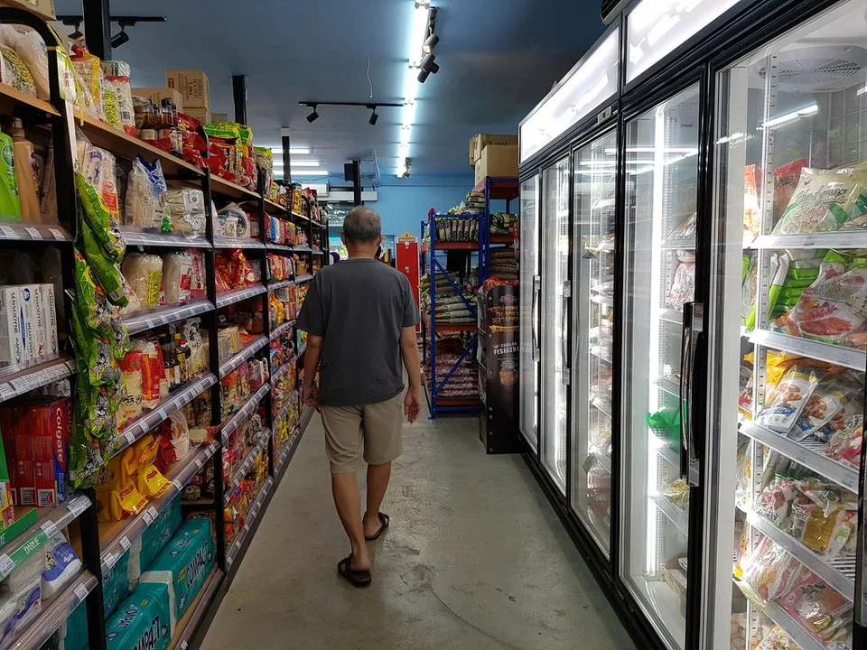 The grocery aisle and refrigerated cabinets inside Go Fresh Market